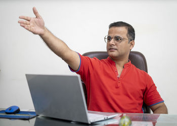 Mid adult man using laptop on table