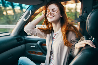 Portrait of happy woman in car