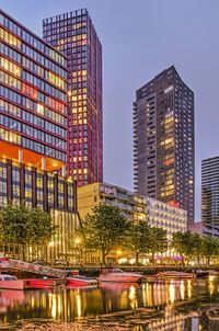 Modern buildings against clear sky at night