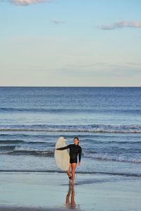 Rear view of man standing on beach