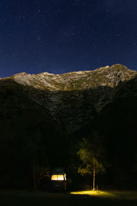 Scenic view of snowcapped mountains against sky at night