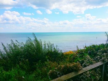 Scenic view of sea against cloudy sky