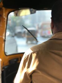 Rear view of man in car