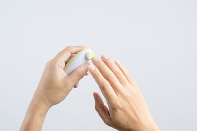 Close-up of woman hand against white background