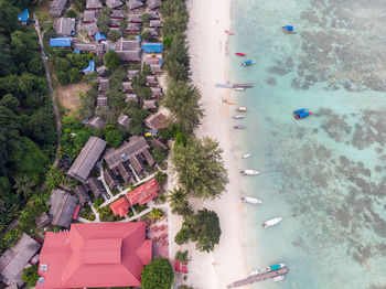 High angle view of houses at beach against trees