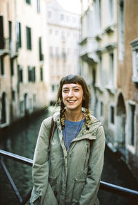 Portrait of young woman by canal