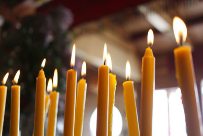 Close-up of lit candles in temple