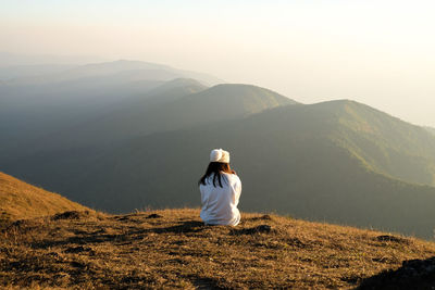 Asia woman sitting on top of mountain
