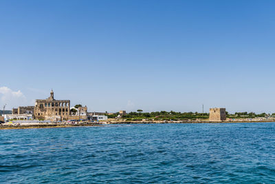 Buildings in city against clear sky