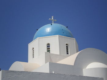 Low angle view of white building against clear blue sky
