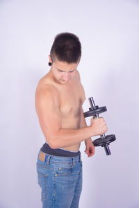 Mid adult man standing against white background