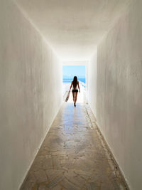 Rear view of woman walking in corridor