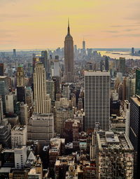 Aerial view of buildings in city during sunset