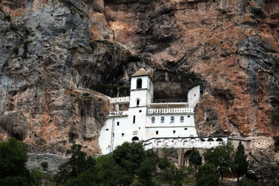 Low angle view of ostrog monastery on mountain