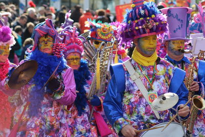 Group of people holding multi colored umbrellas