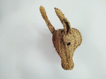 Close-up of wicker decoration over white background