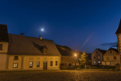 Buildings against sky at night