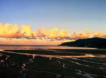 Scenic view of beach against sky during sunset