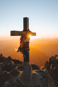 A cross at the summit of mont valier, pyrenees at sunrise.