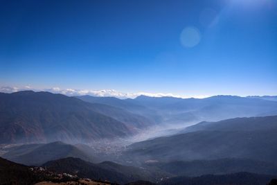Scenic view of mountains against clear blue sky