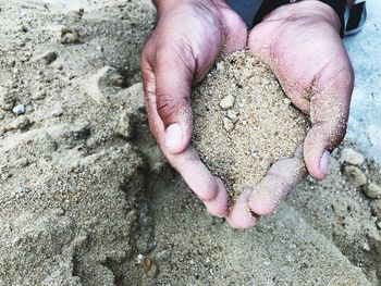 Close-up of hand holding sand