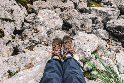 Low section of person standing on rock