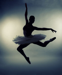 Silhouette ballet dancer performing while wearing tutu