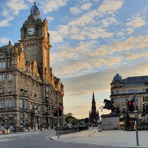 Buildings in city against cloudy sky