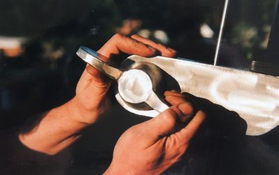 Cropped image of person holding metal