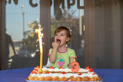 Portrait of smiling girl on cake