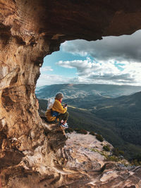 Me standing on rock against sky