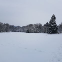 Snow covered landscape against clear sky