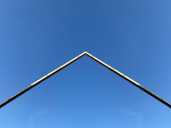 Low angle view of metallic structure against clear blue sky