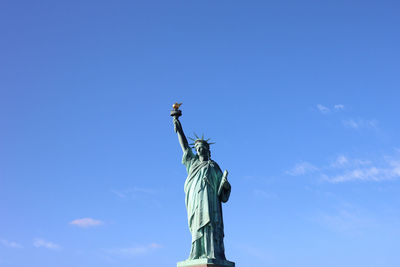 Statue of liberty in front of blue sky