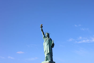 Low angle view of statue against blue sky