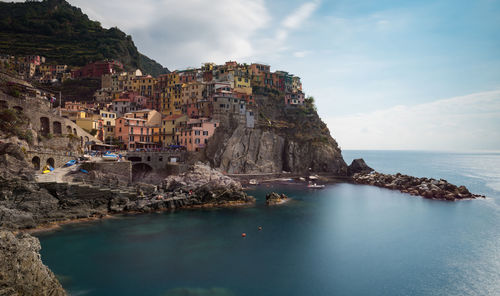 Panoramic view of sea and buildings against sky