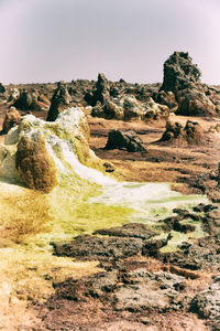 Rock formations on landscape against clear sky