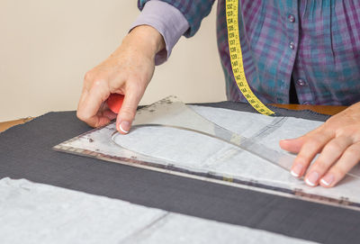 Midsection of man working on table