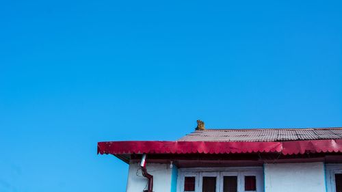 Low angle view of building against clear blue sky