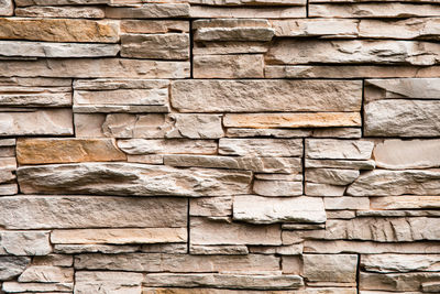 Stone lined with granite wall, sandstone, stone background wall. facing stone, rock texture