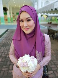 Close-up of beautiful young woman standing outdoors