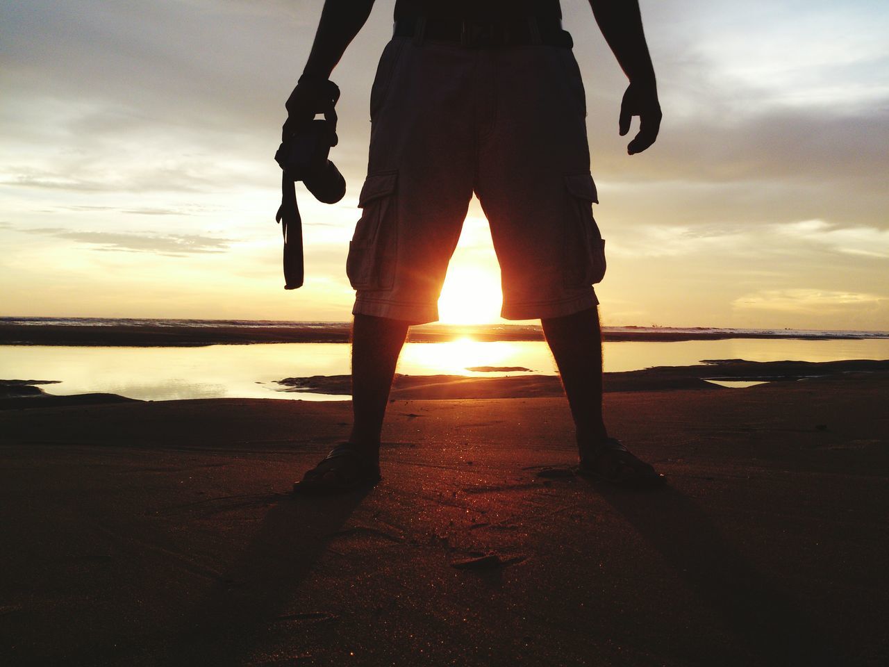 sunset, beach, sea, water, low section, sky, silhouette, shore, leisure activity, lifestyles, men, orange color, standing, person, reflection, horizon over water, sun