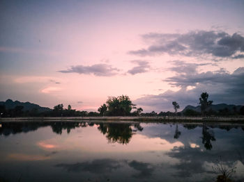 Scenic view of lake against romantic sky at sunset