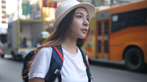 Portrait of beautiful woman standing in city