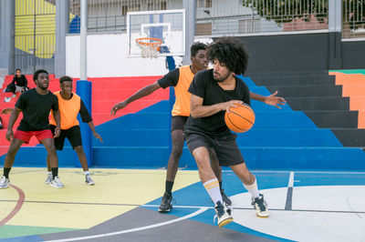 Man playing basketball at court