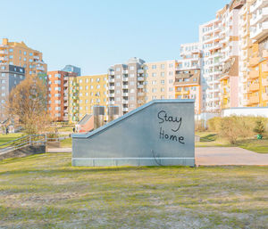 Graffiti on building in city against clear sky