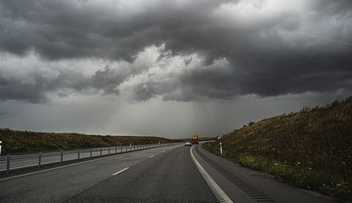 Road passing through storm clouds