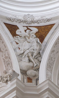 Directly below shot of ornate ceiling in building