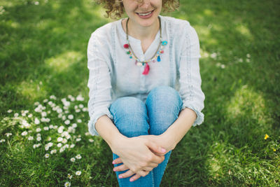 Portrait of a smiling young woman sitting on grass