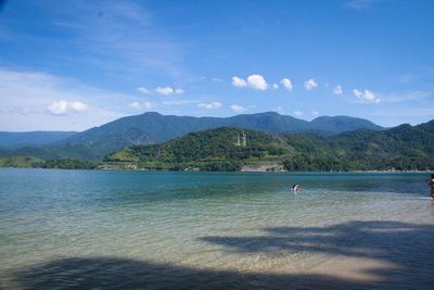 Scenic view of lake against cloudy sky